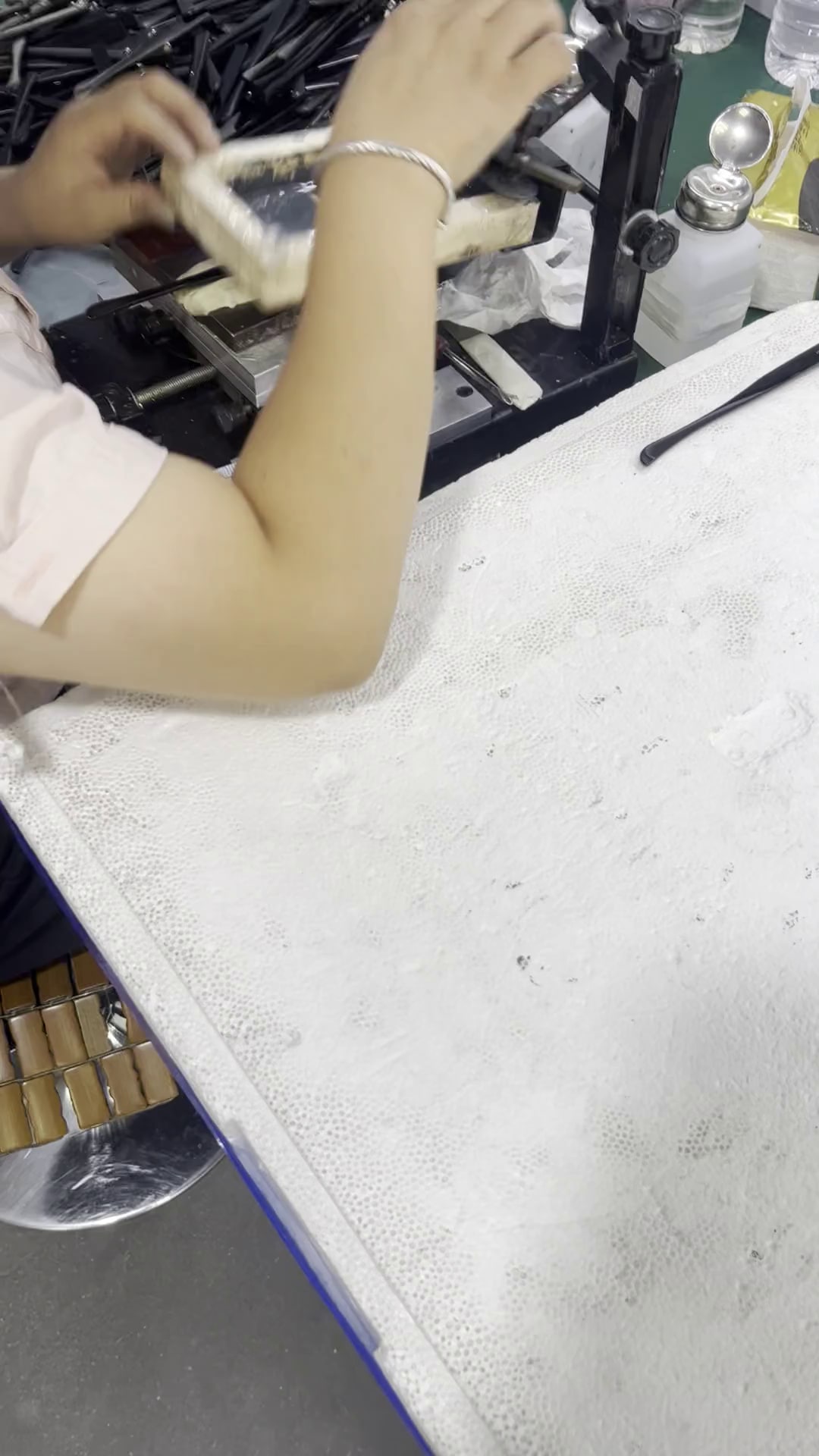 Operator printing the base layer for a cold foil eyewear logo